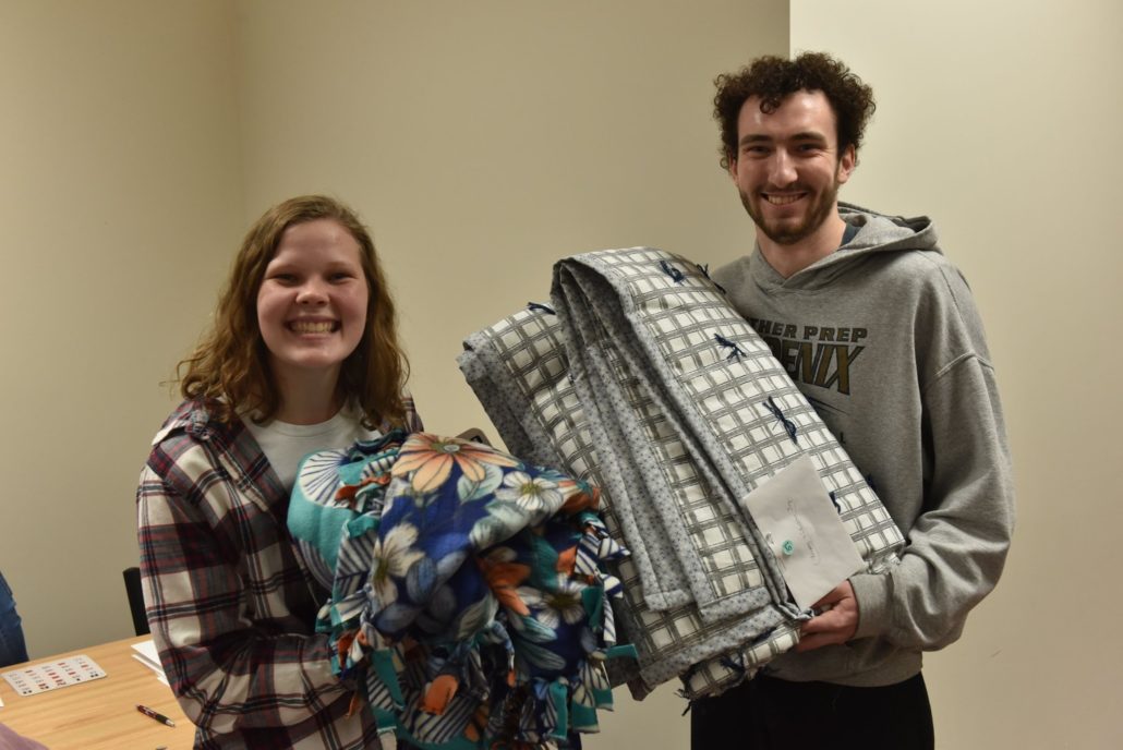 Martin Luther College students show the blankets they won from the MLC Auxiliary