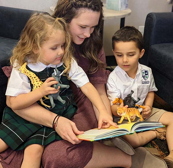 Lydia Thiesfeldt reading to two preschool children