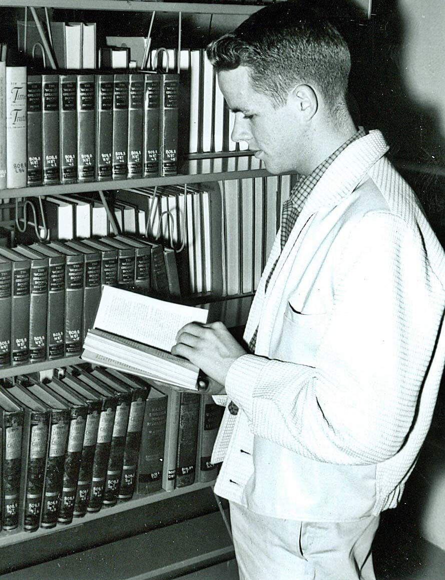 Carl Pagel as college student in library, 1960