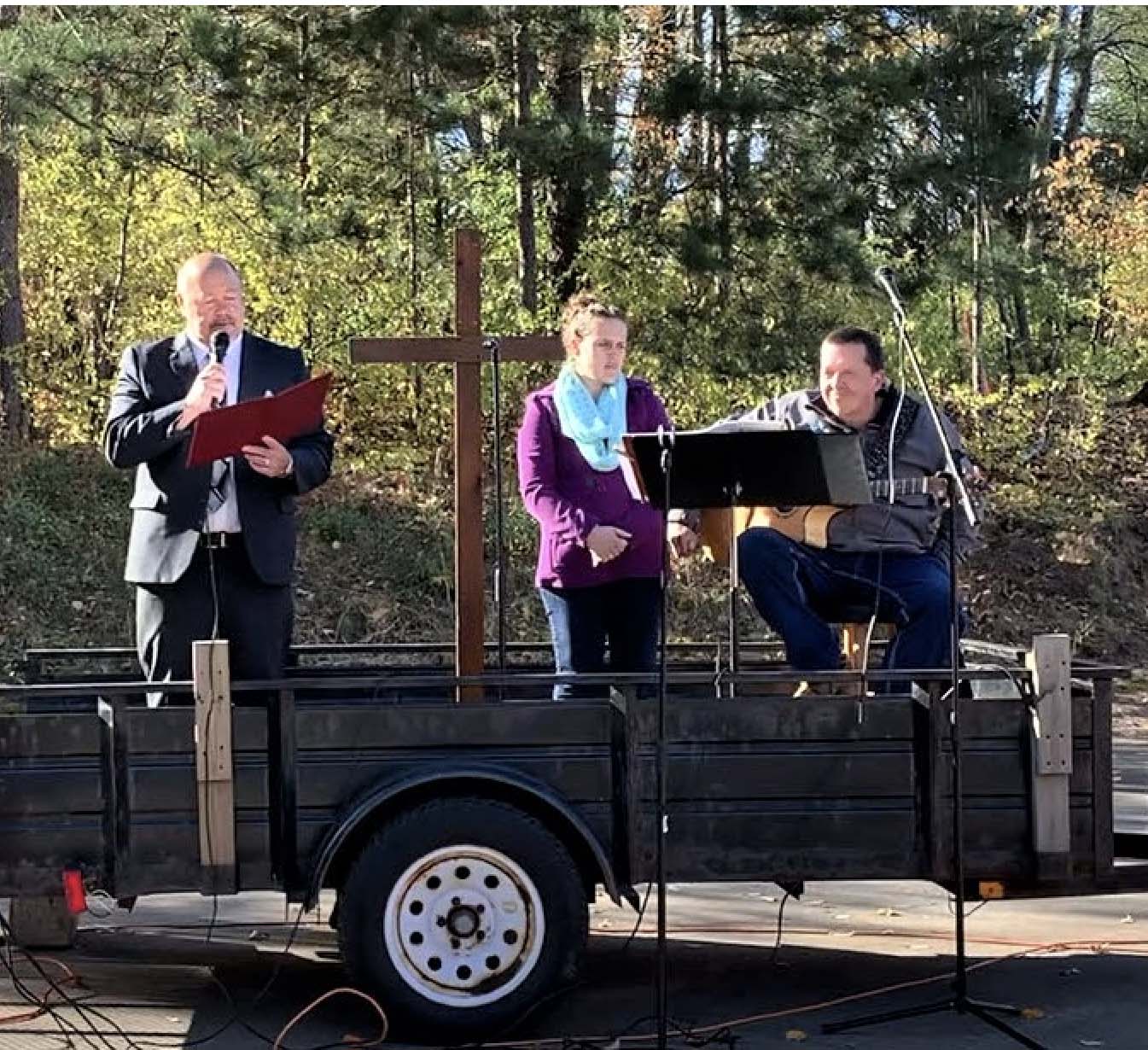 Mark Gass leading worship outdoors in a trailer