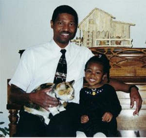Pastor Snowden Sims with daughter Erika as a young child