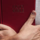 man holding bible close to heart