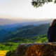 woman sitting with back to us looking at landscape