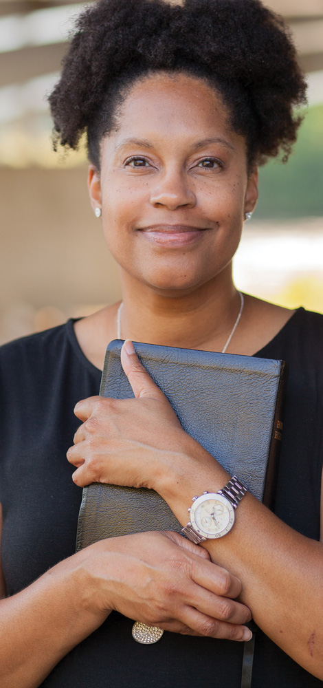 woman holding bible close to heart