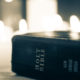 Bible with candles in background