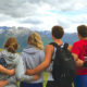 teens looking at mountains with back towards us