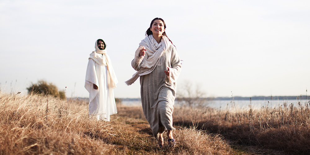 Woman running to tell about Jesus with Jesus in the background