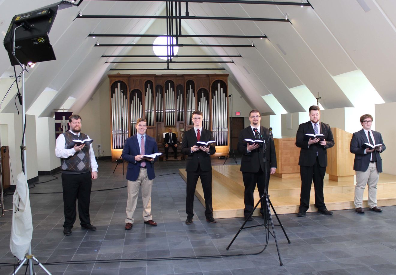 Choir of six Wisconsin Lutheran Seminary students singing and Prof. Aaron Christie playing organ