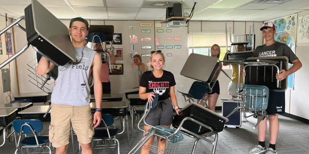 Teens moving school desks Northern Wisconsin SEPT 22