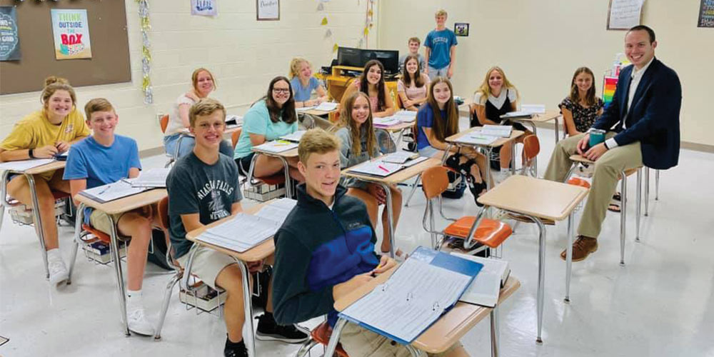 Teens at their desks with teacher SEPT 22