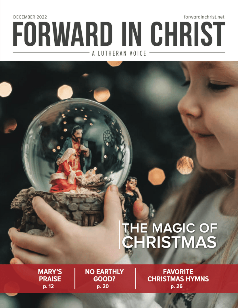 Cover of December 2022 issue of Forward in Christ, girl with snow globe nativity
