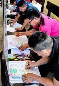 Men in Peru coloring a Bible story with a serpent