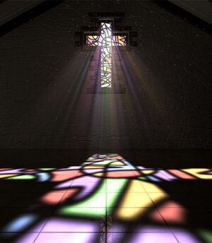 colorful stained glass cross reflection on floor