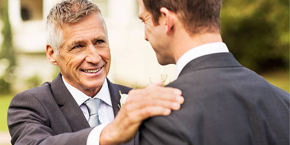 father of groom talking to son