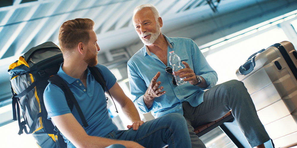 Two men talking in airport