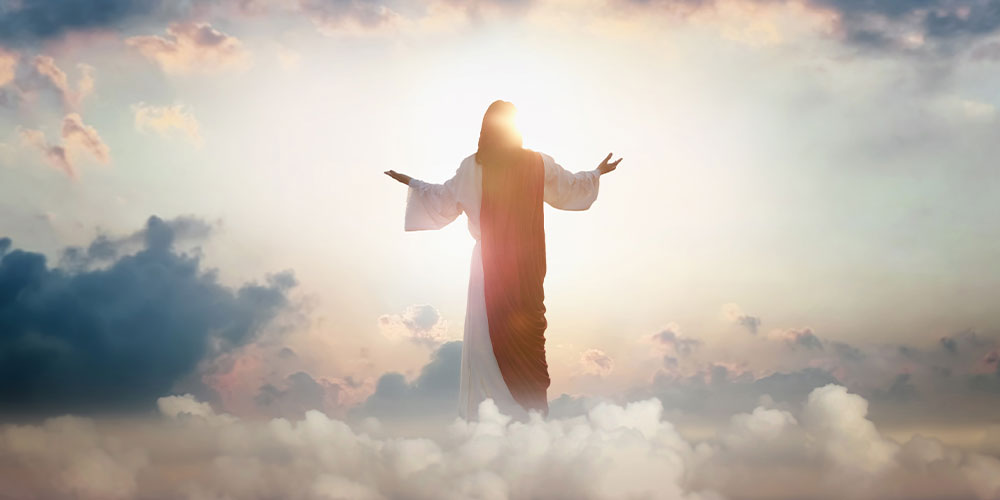 Jesus with hands outspread standing in clouds