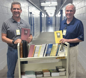 Matt Brownand Don Tollefson at the Harris County jail with some of the devotion books provided by Institutional Ministries