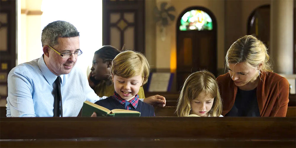 Parents and children in church sitting in pew