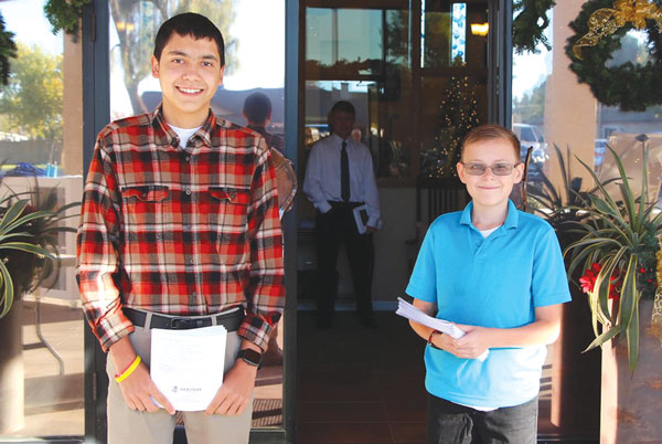 two boys greeting church goers before mass