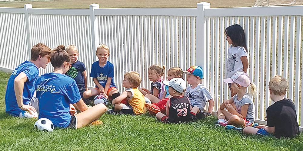 teens teaching a soccer camp