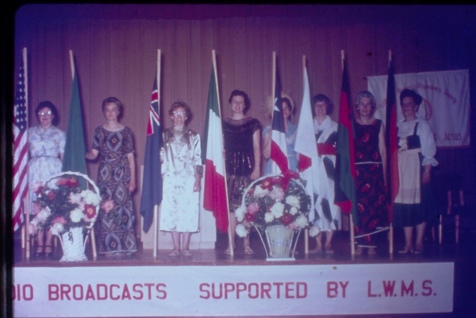 Women with flags on stage