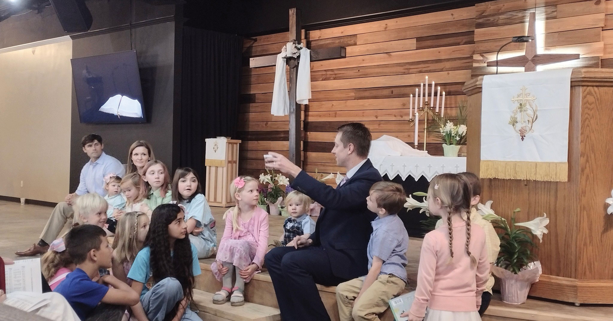 Living Hope, Chattanooga, Tenn. pastor taking to children sitting on the stairs of church easter