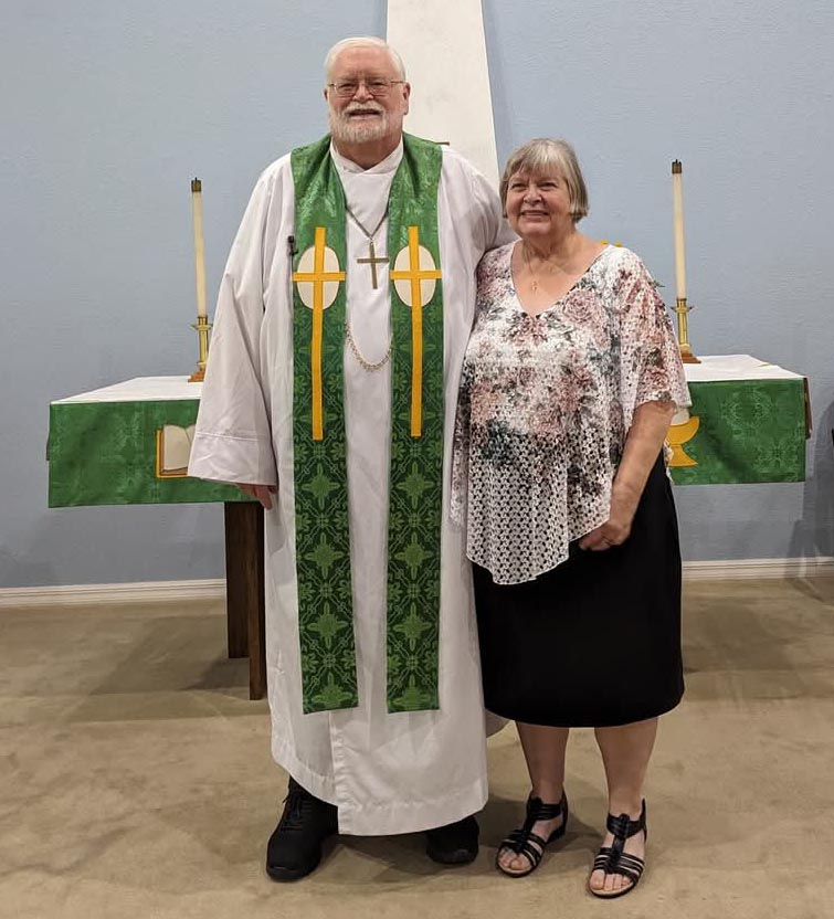 Alan Gumm and his wife at his retirement service; pictured in front of church