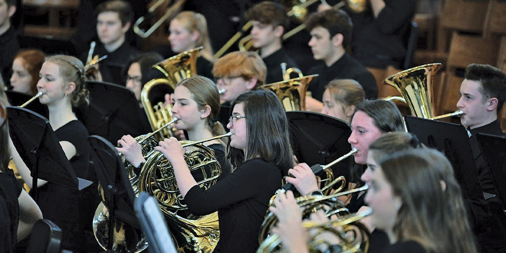 students playing tuba and horn wearing black
