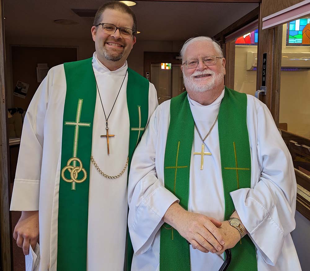 Jeremiah and Alan Gumm at Alan Gumm's retirement; the pair are wearing pastoral robes and stoles