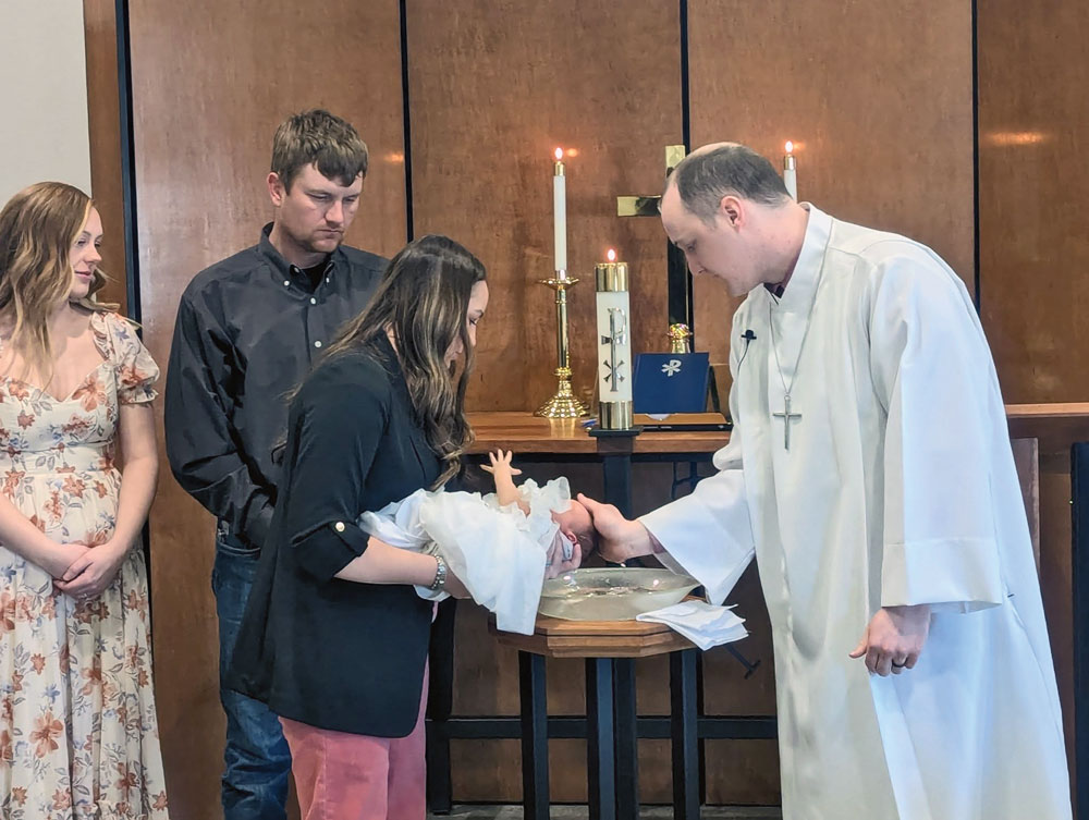 small infant being baptized
