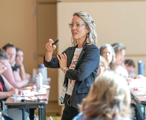 woman talking at conference to other women
