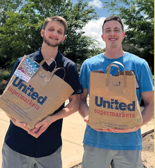 two college aged men delivering food