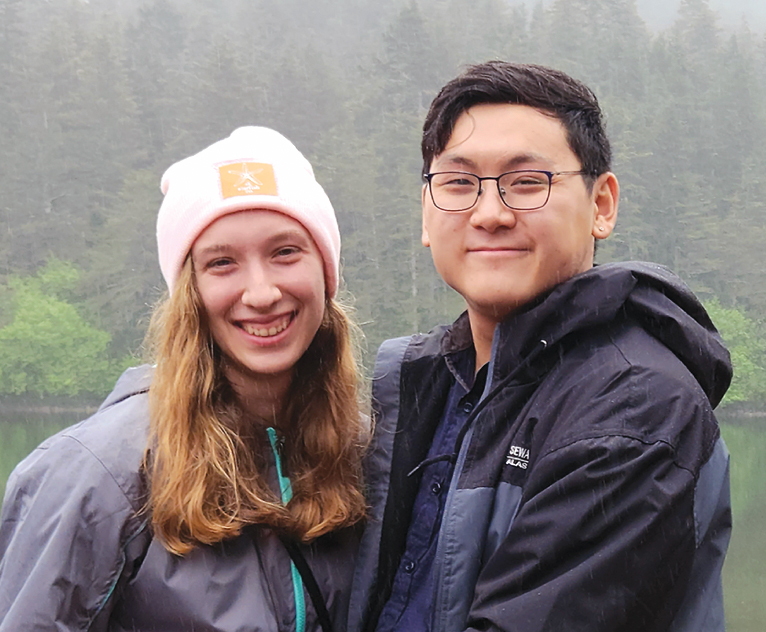 asian man with woman in pink hat and grey jacket
