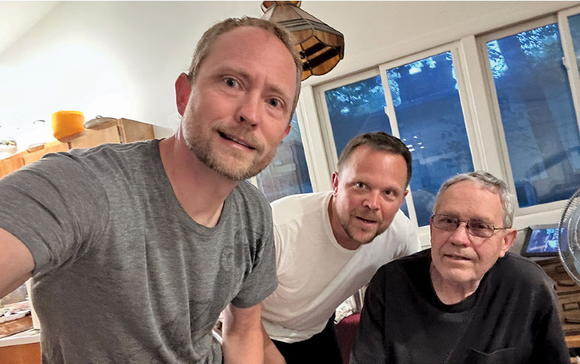 three men taking a selfie wearing tshirts grey white and black