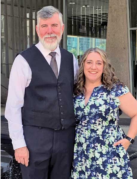 Man and woman pose for photo