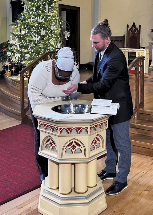 baptism during chistmastime man and woman wearing white