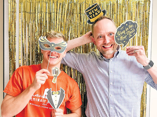 Joel Seifert and youth during new years party orange shirt