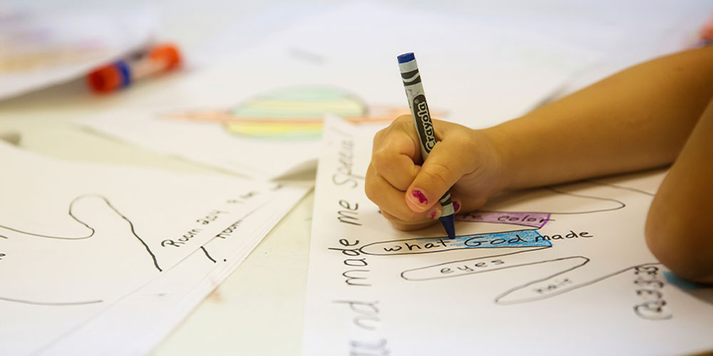 little girl coloring a hand what God made blue crayon