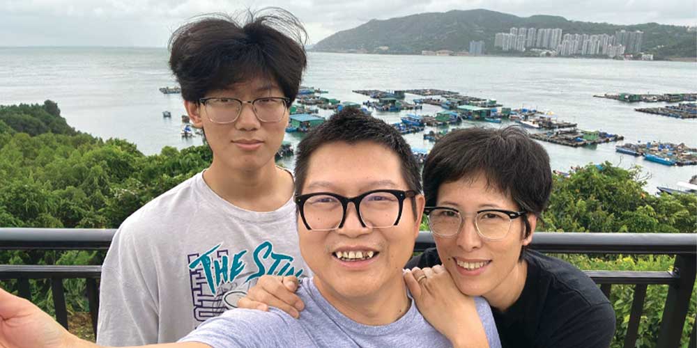 asian couple with son taking selfie