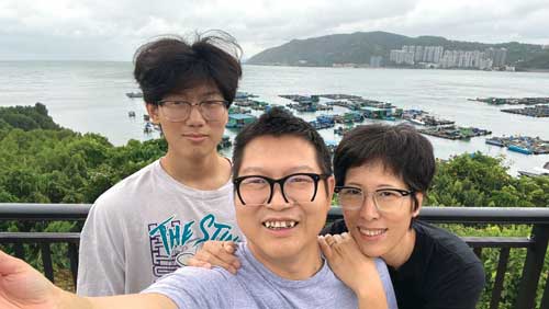 asian couple with son taking selfie