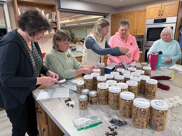 women making trail mix for homebound