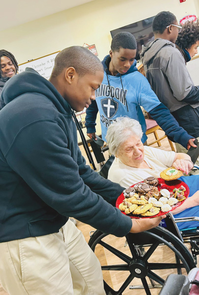 Christmas cookie distribution by Kingdom Prep Lutheran High School wheelchair