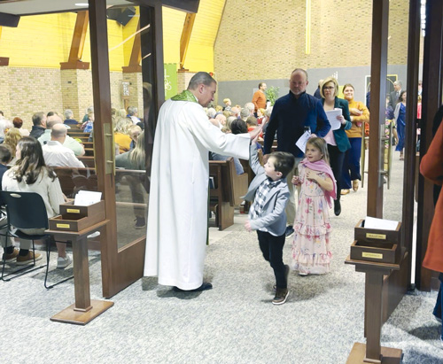 Post-service high fives in church with kids and pastor