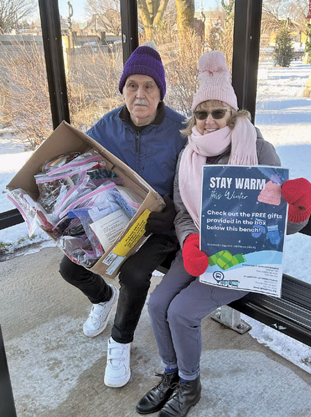 stay warm giveaway of hats man and woman in bus stop