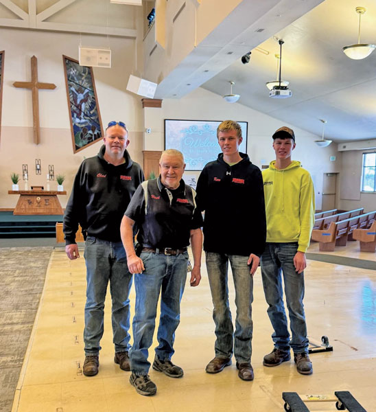 males in work clothes standing in church construction