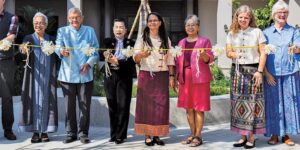 Thai Village opened and dedicated a new training facility woman and men waiting to cut the ribbon