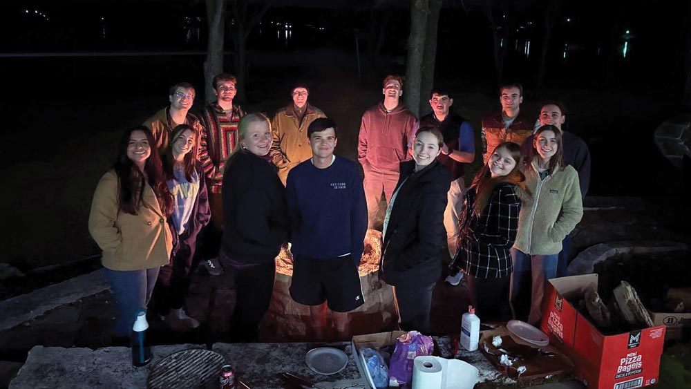 Campus Ministry retreat around a campfire