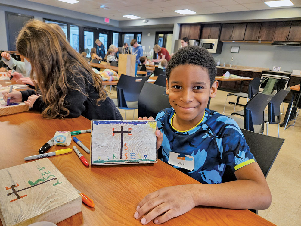 Easter for Kids young boy making a cross with markers