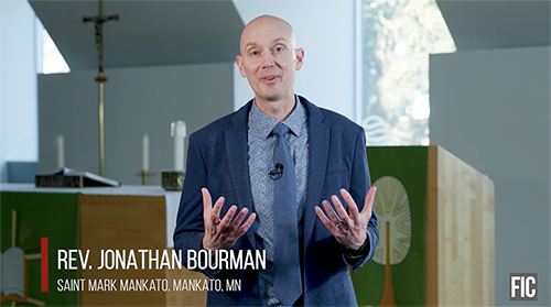 Jonathan Bourman speaking in front of the Wisconsin Lutheran Seminary's altar and pulpit area