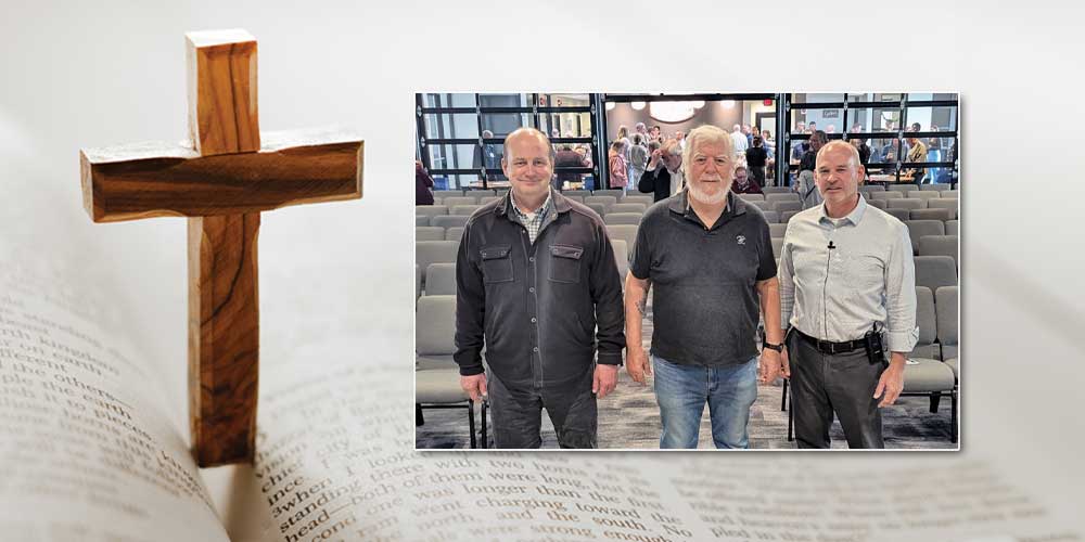 wooden cross on bible with photo of 3 men